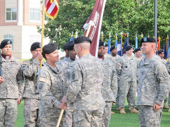 Col. Ron Place presents unit colors to new WTB commander LTC Rosemarie Deck