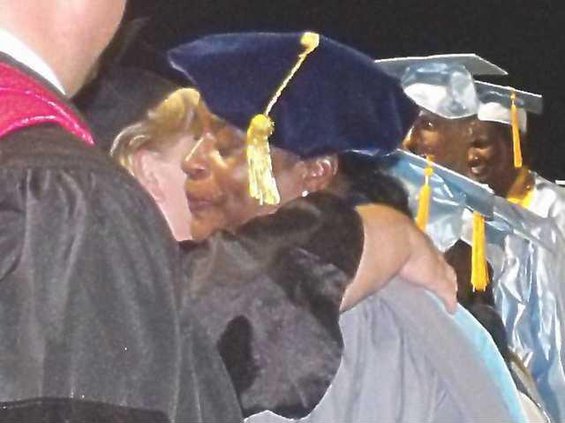 Dr. Mallard hugs a fellow teacher