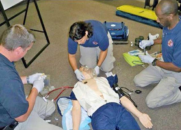 HFD senior firefighters Graham Martine Marta Cuevas and Fire Marshal Ernest McDuffie taking an EMT class