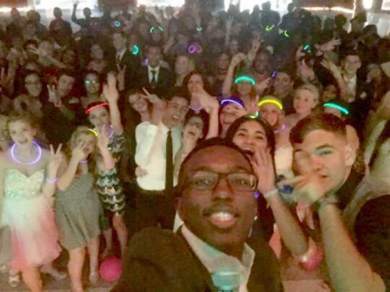 Keinan Johnson takes a selfie with a large group of Bradwell students at the Midnigt in Paris-themed homecoming danceweb
