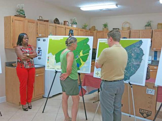 Nancy King looks at revised land use map with Jones and Patenaude 