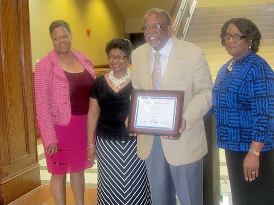 Representative Al Williams holds his recognition certificate for being named Legislator of the Year. left to right Dr. Valya Lee Olivia Williams wife Board Chairwoman Lily Baker