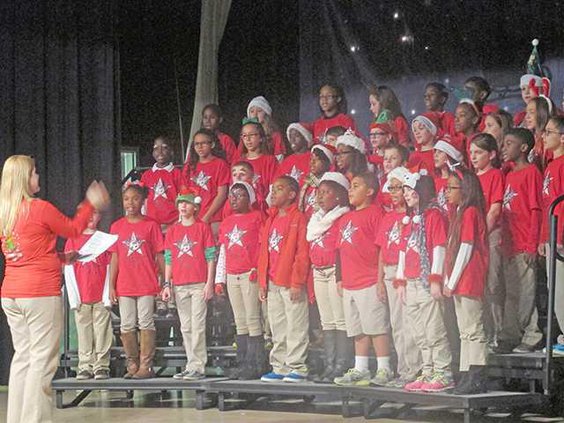 The Taylors Creek Elementary School chorus sings Jingle Bell Rock for an audience of parents family and other community members at the Holiday Extravaganza