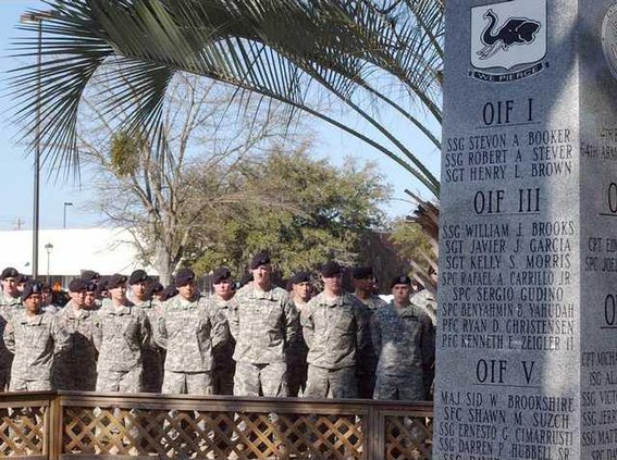 soldiers stand behind wall