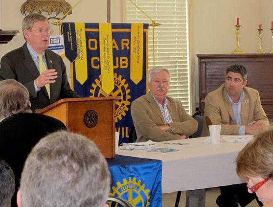 Isakson speaking with Wayne Dasher and GA Rep. Delvis Dutton at VIP table