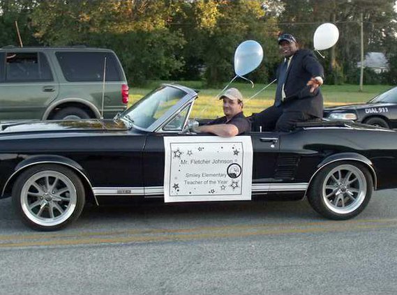 4---SES Teacher of the Year Fletcher Johnson waves to the crowd at the HC Parade.