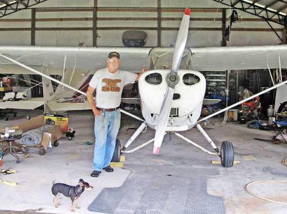 Berg standing with one of his aircraft