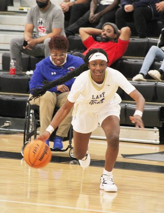 Ja’Nya Bush begins her path to the basket against the Griffin girls.