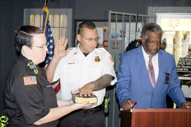 John Pittman takes his oath of office as Walthourville fire chief from Mayor Larry Baker.