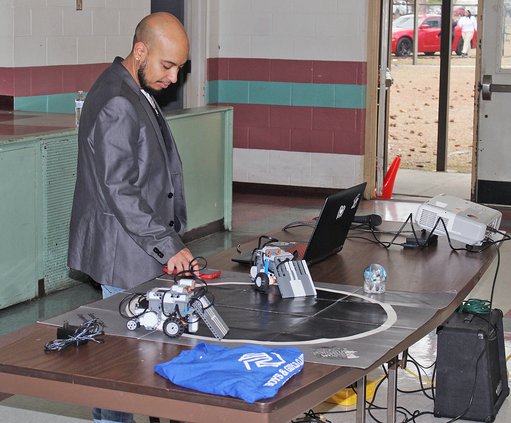 Luis Camacho sets up a robotics display for the Liberty County Boys and Girls Club