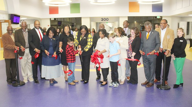 Liberty County dignitaries, along with Liberty Elementary School staff and students, cut the ribbon on the renovations to the school.