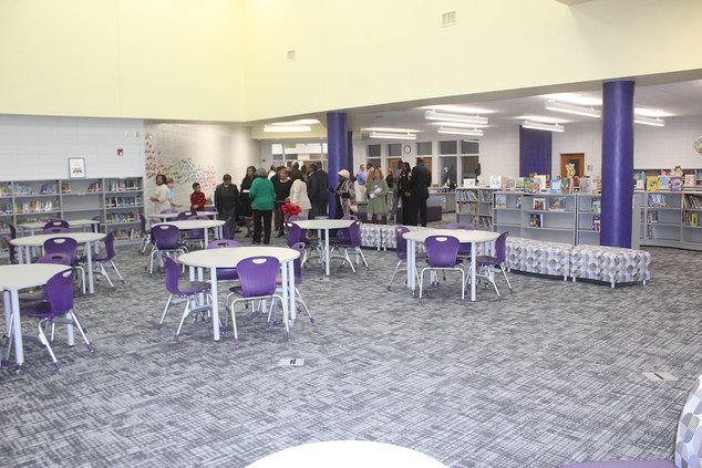 Liberty Elementary School staff and students show off the school’s new media center to visitors Thursday evening.