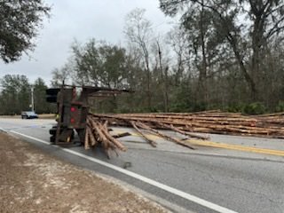 Overturned log truck shuts down road - Coastal Courier