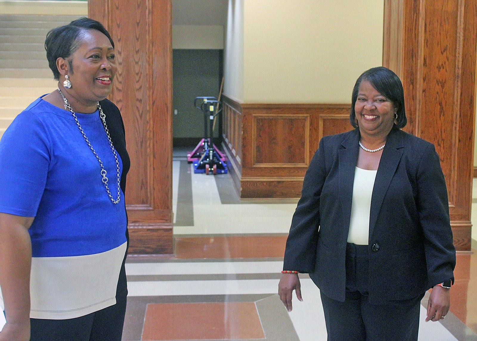 Verdell Jones and Debra Frazier, the interim superintendent, share a laugh.