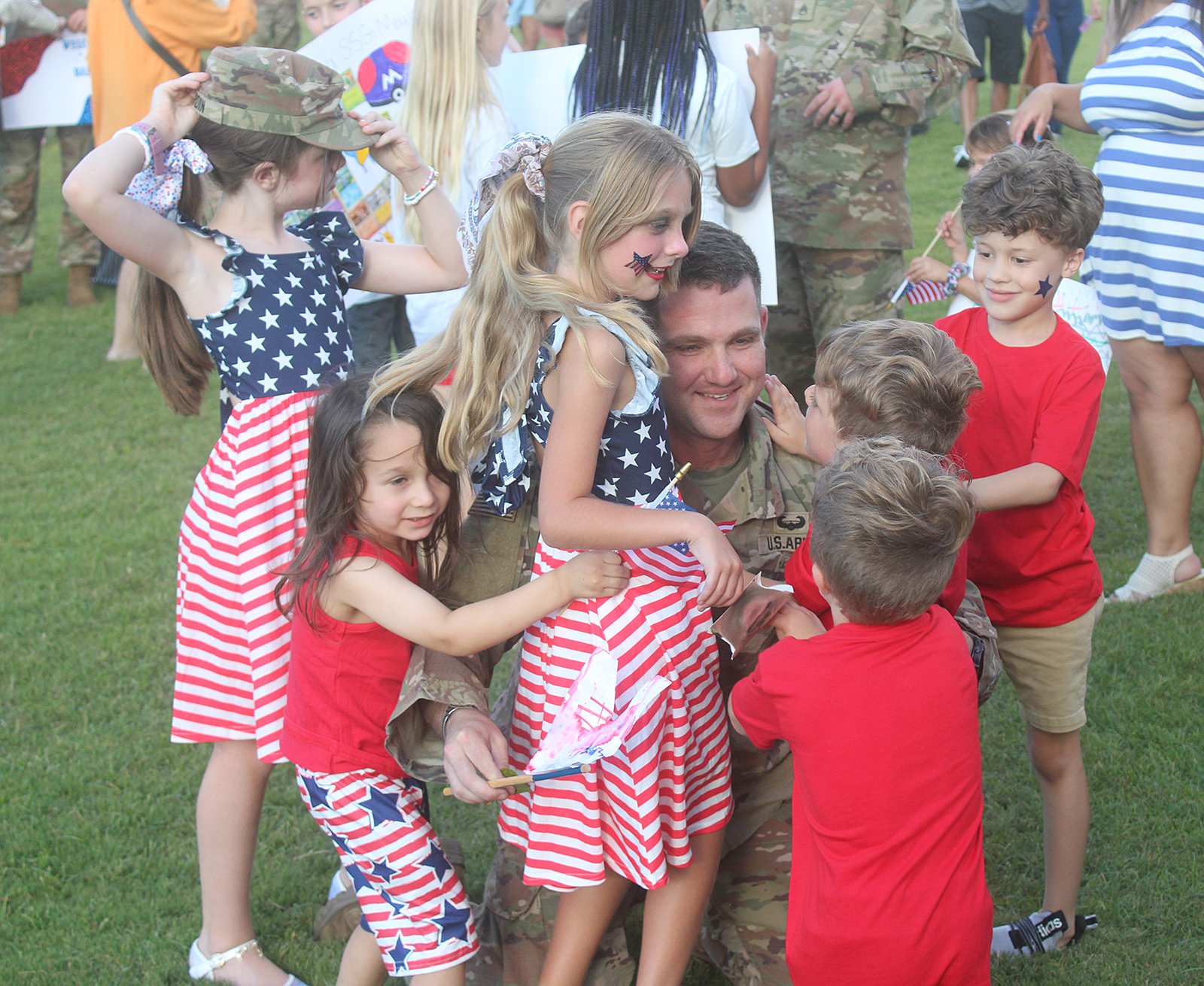 Sgt. 1st Class Andrew Hardin is swarmed by his children following the end of his nine-month deployment.