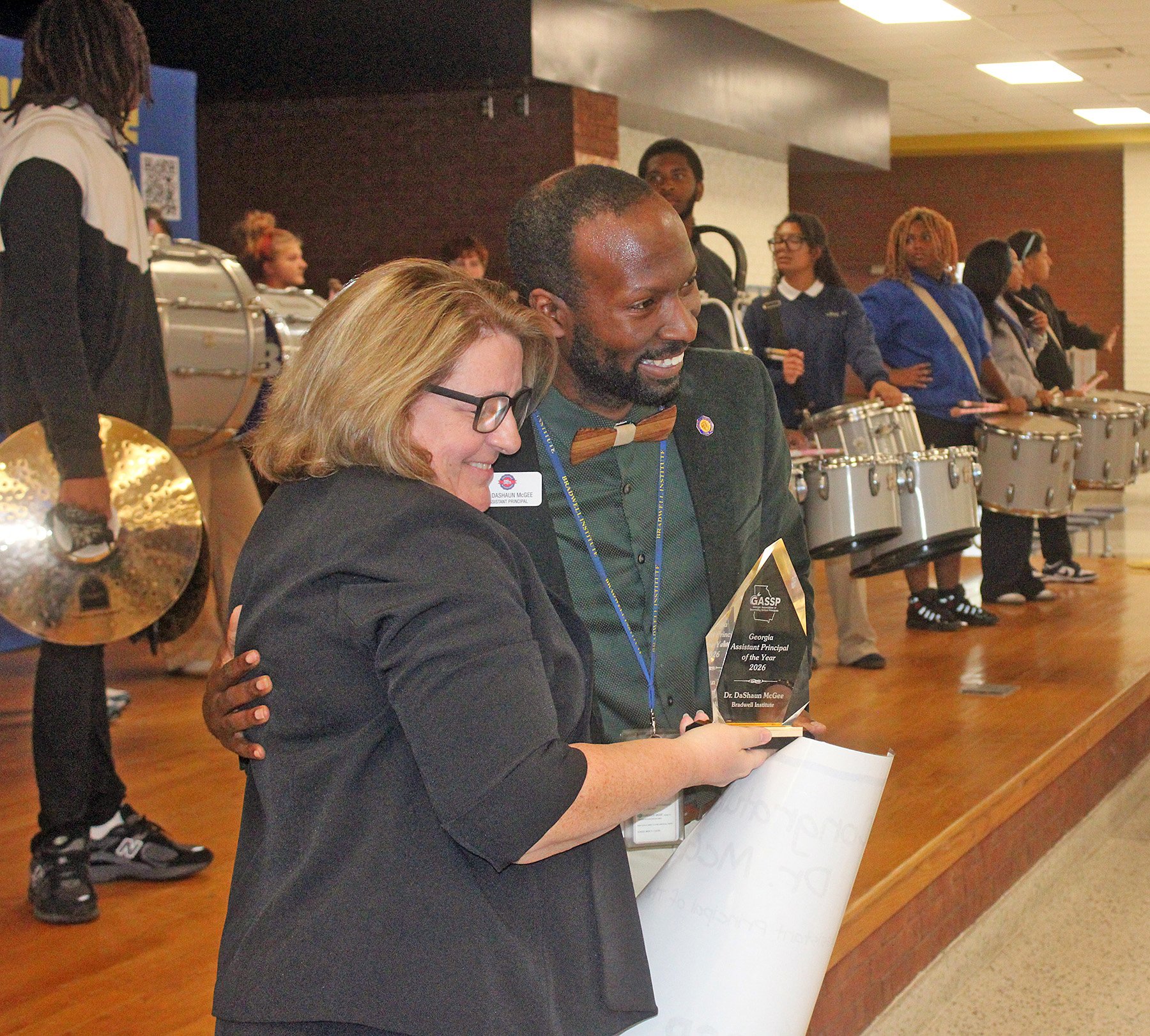 Dr. Mary Ryan, interim principal at Bradwell Institute, congratulates Dr. DeShaun McGee after he was named statewide assistant principal of the year.