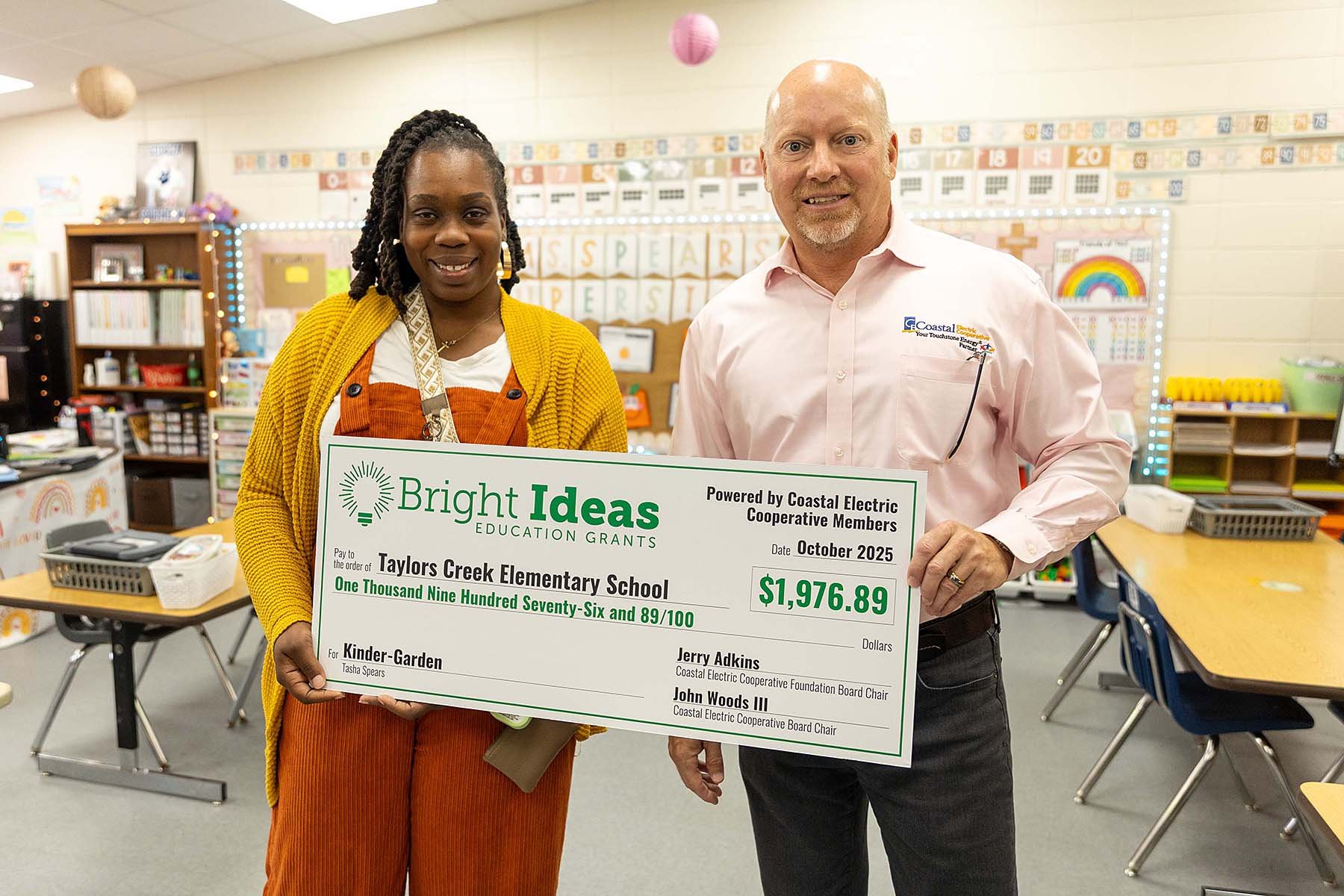 Fettes delivers a check for $1,976.89 to Taylors Creek Elementary School’s Tasha Spears.
