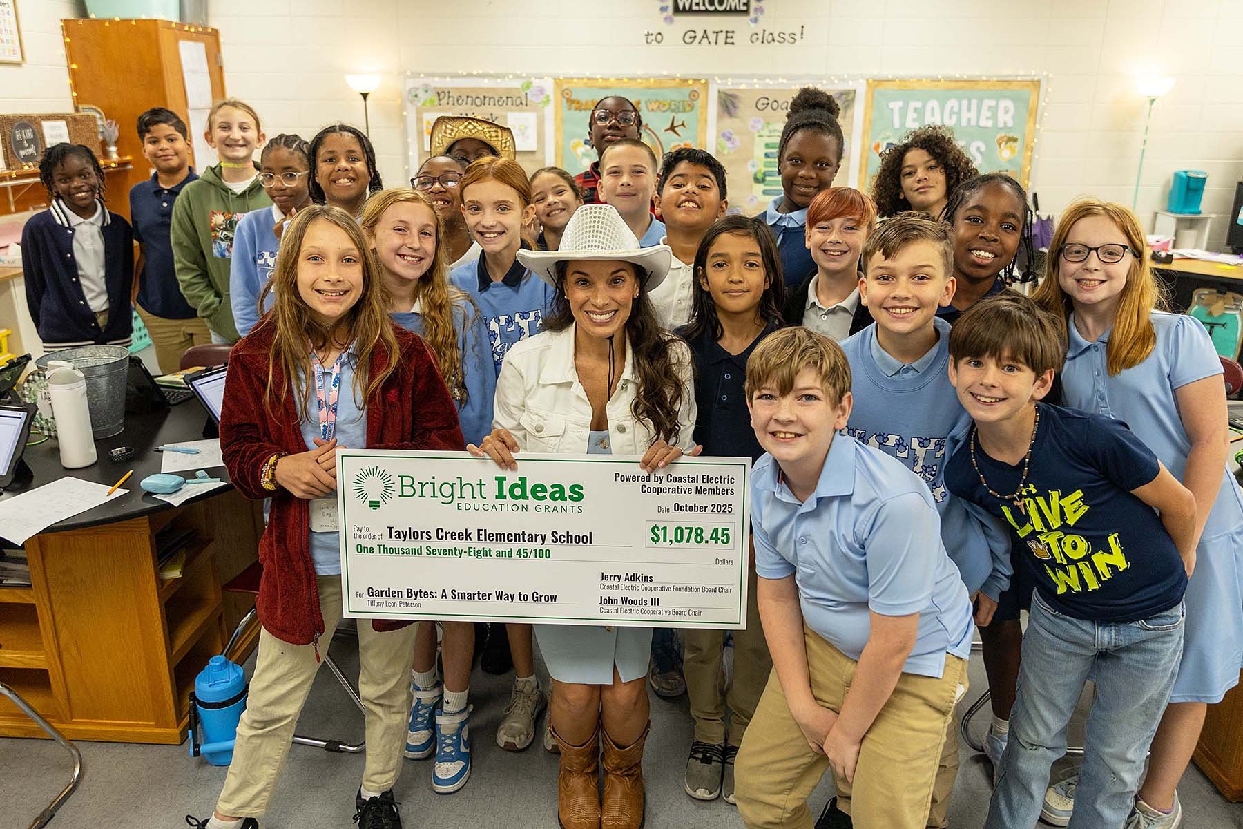 Taylors Creek’s Tiffany Leon-Peterson gets help from her class in celebrating her Bright Ideas grant.