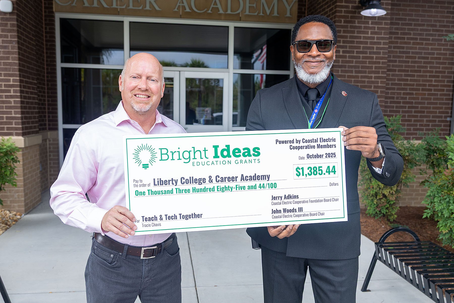 Coastal EMC CEO Chris Fettes delivers Tracie Chavis’ Bright Ideas check to Liberty College and Career Academy CEO Roland VanHorn.