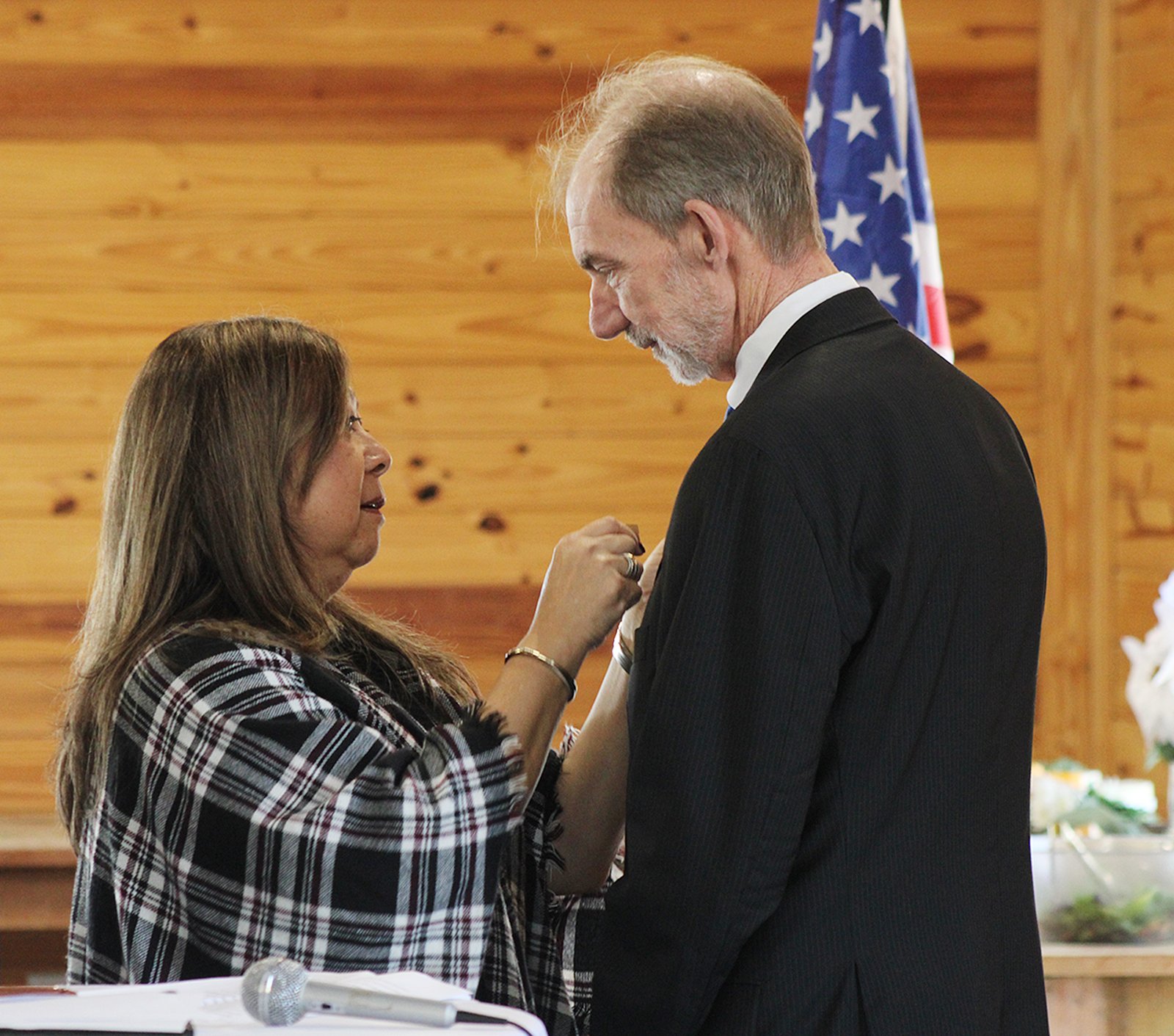 Shanken’s wife Brigitte places his pin on his lapel.